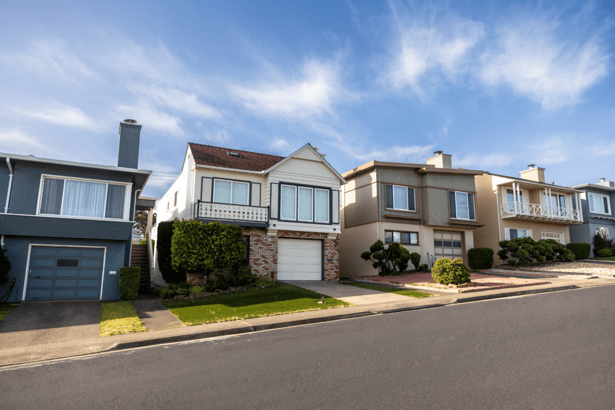 Row of suburban homes under blue sky